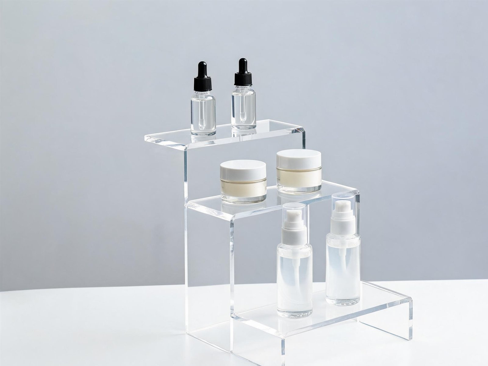 Three-tier acrylic display stand with cosmetics
